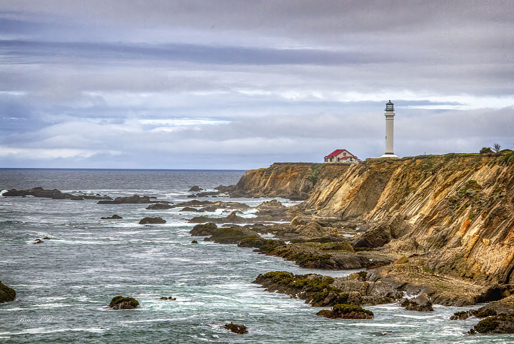 Rocky coast, harsh wave and an elegant lighthouse.