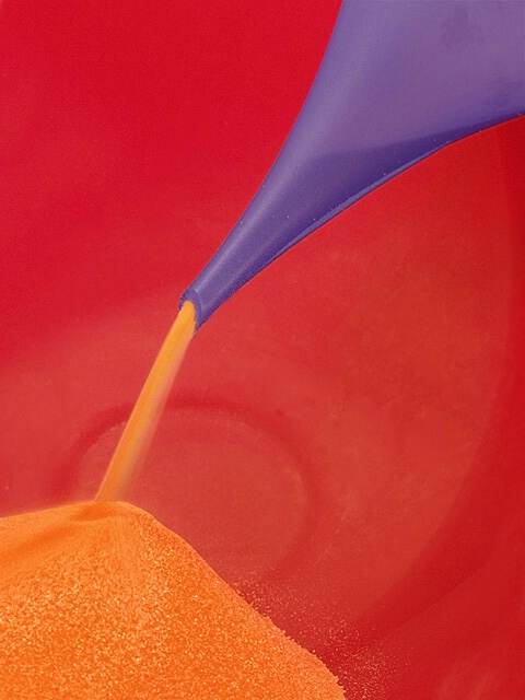 Orange Sand Through Purple Funnel Into Red Bowl