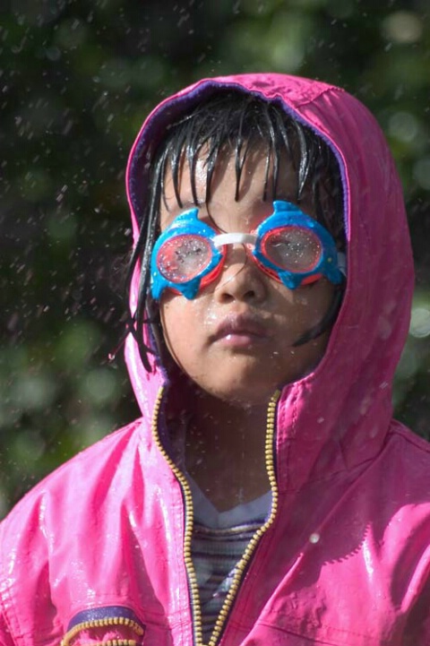 Young girl with goggles and raincoat
