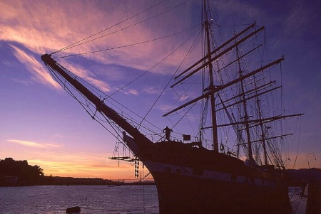 Historic Ship and Tourist Silhouette