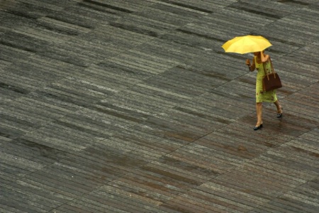 Woman With Yellow Umbrella In The Rain