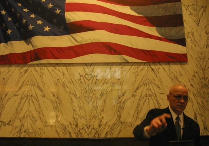 Man Pointing With Flag Before