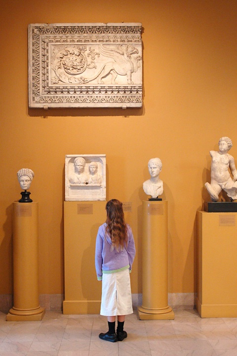 Girl viewing Roman sculpture