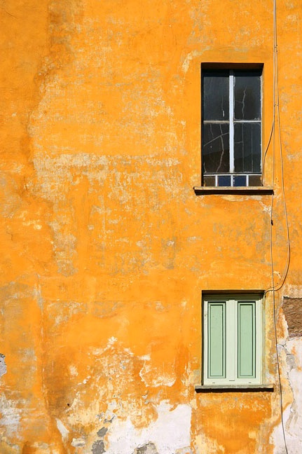 Two windows on orange wall