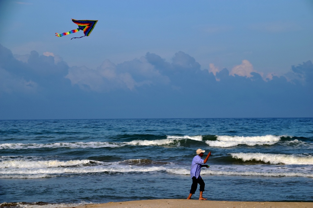 FLYING A KITE AT THE BEACH