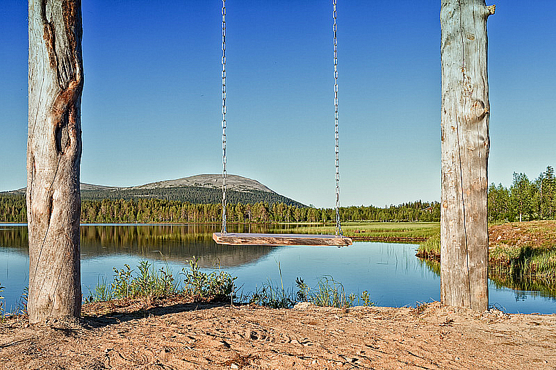Wooden Swing By A Lake