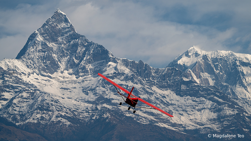 Red Plane at Himalayan Mountain Range