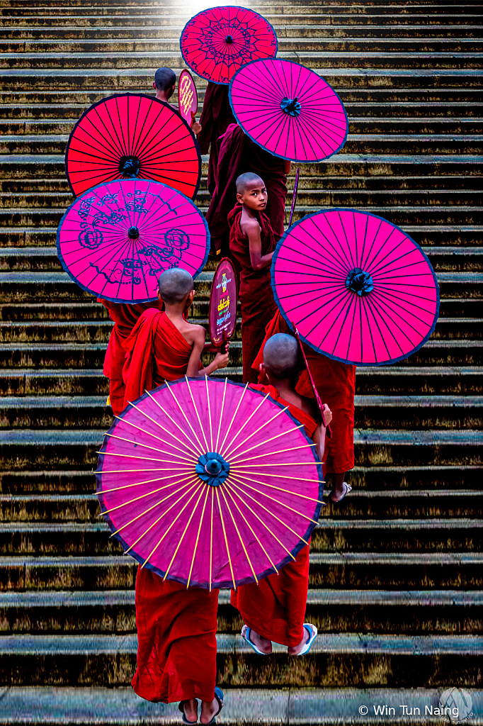 Monks climbing stairs in a row