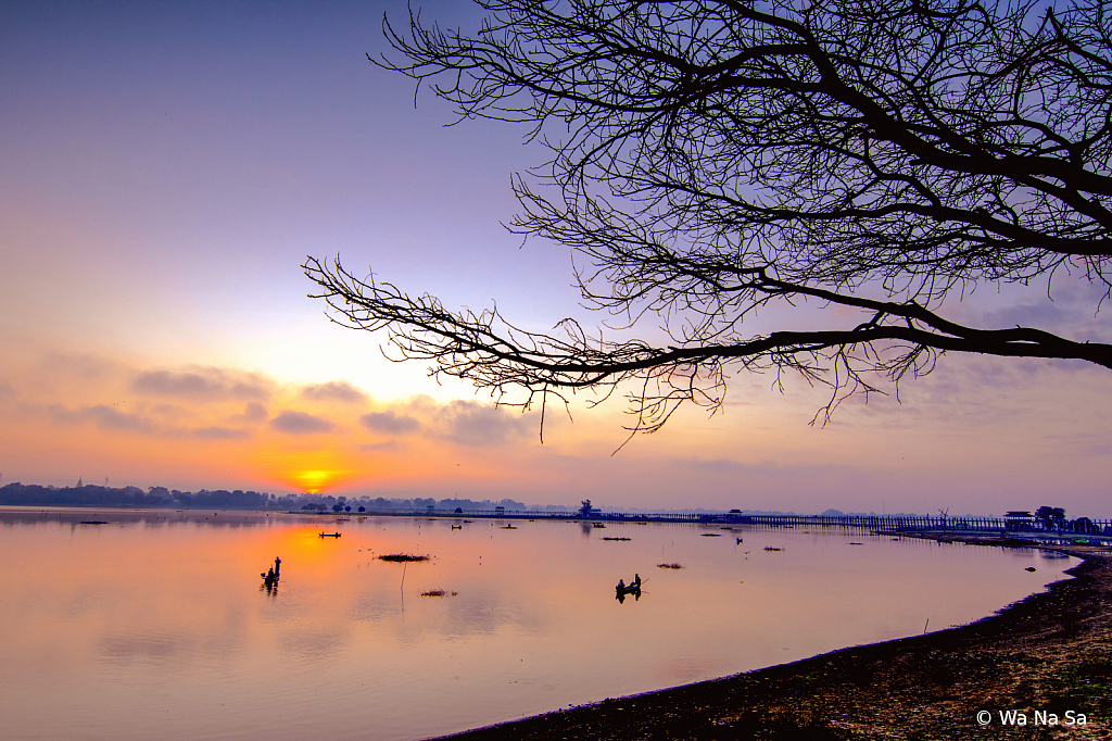 Fishermen under sunrise.