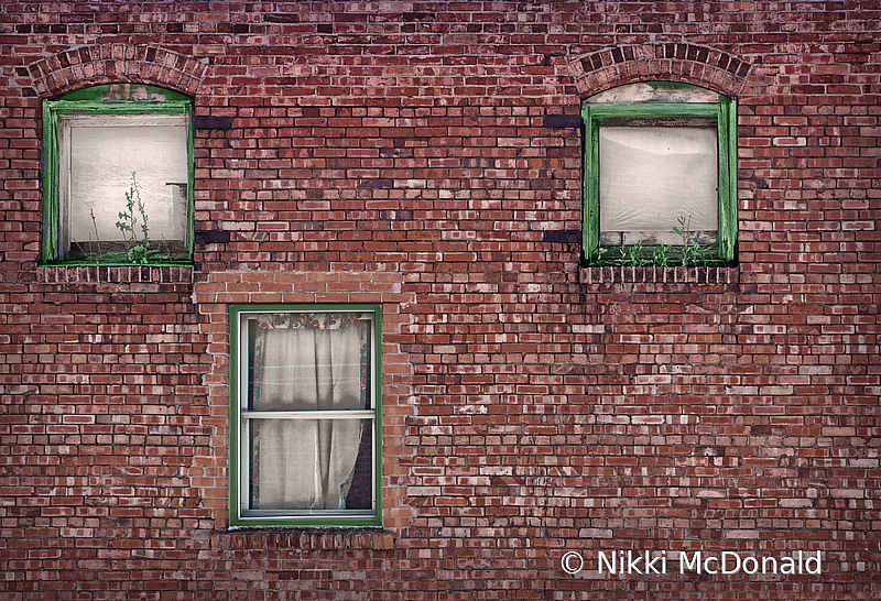 Three Windows in Brick Building