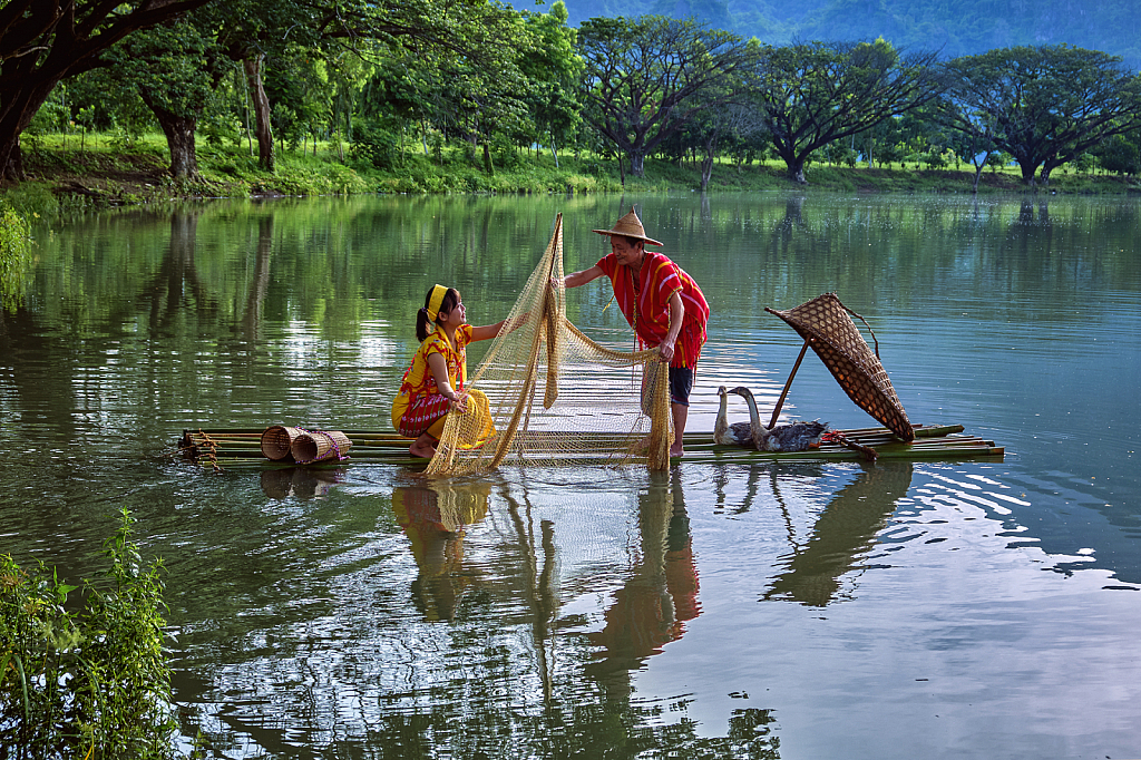 An old Karen man and his daughter are fishing