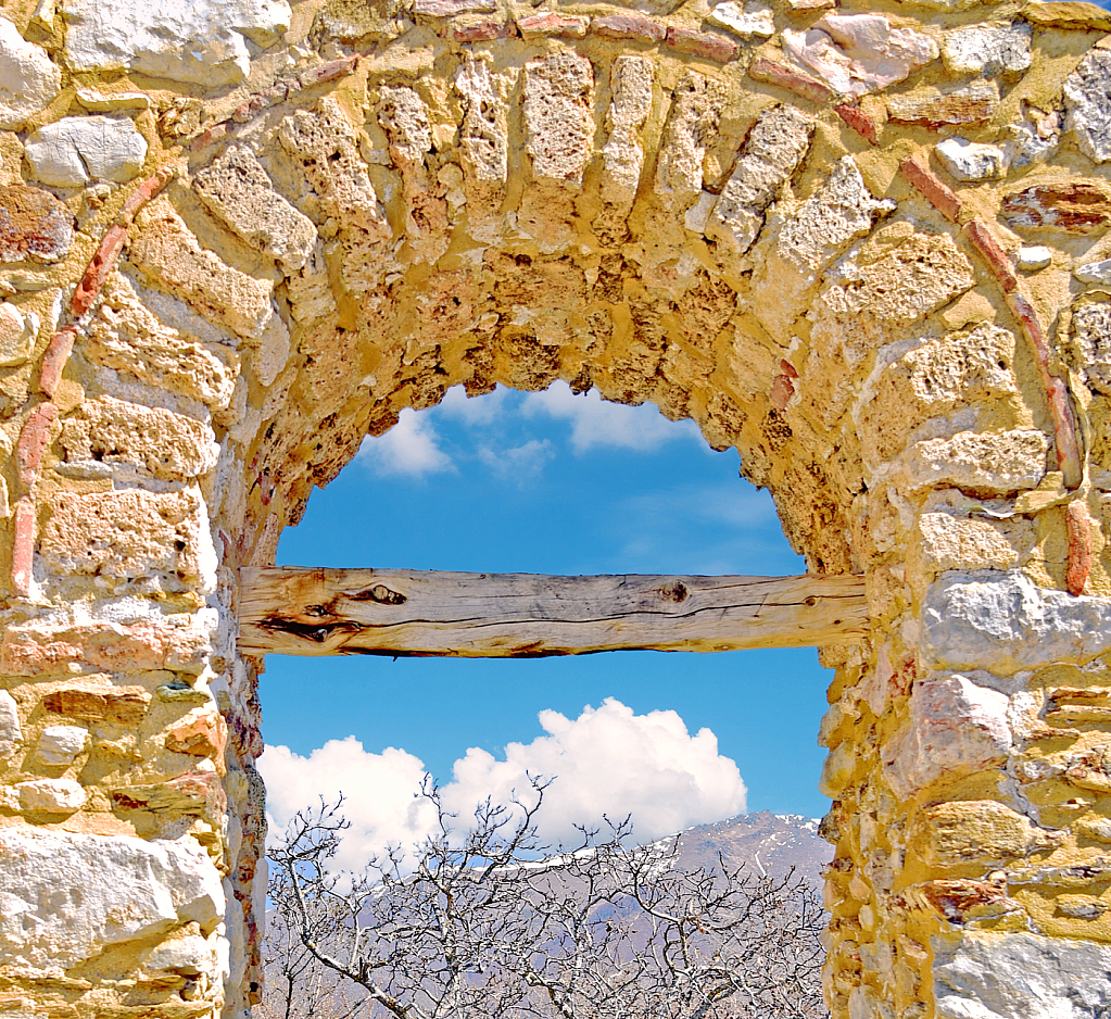 Ancient Arch framing Sky and Mountain.