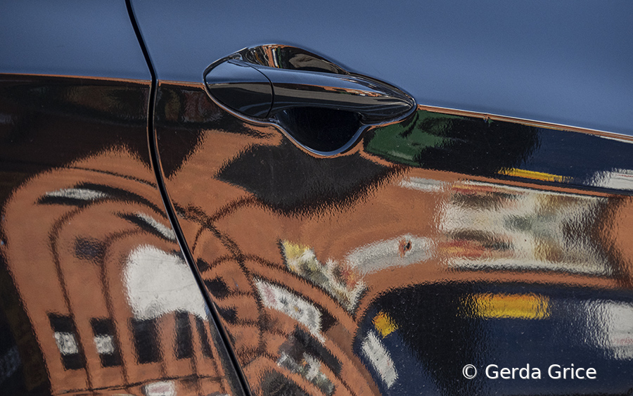 Reflections on a Car on a Blue Sky Day