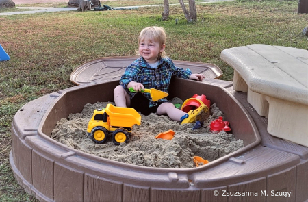 Joy playing in the sandbox