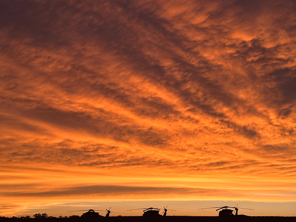 Glorious sunset over the military helicopters