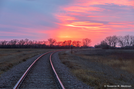 Follow the railroad tracks to the sunset