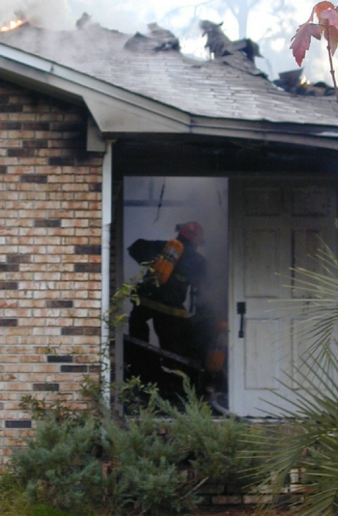 Firemen inside burning house