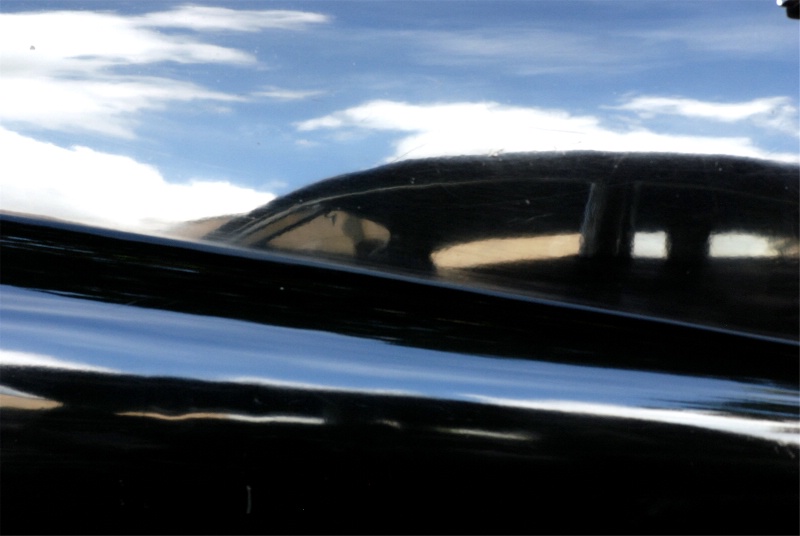 REFLECTIONS OF A CAR ON A POLISHED CAR