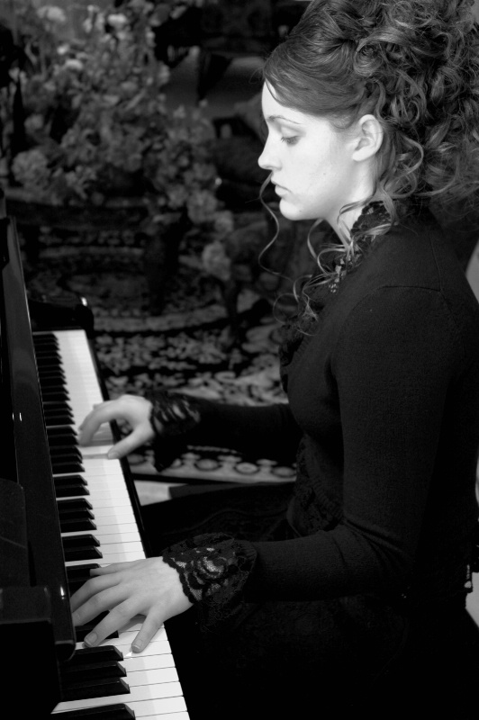 Kendra at the piano by window light