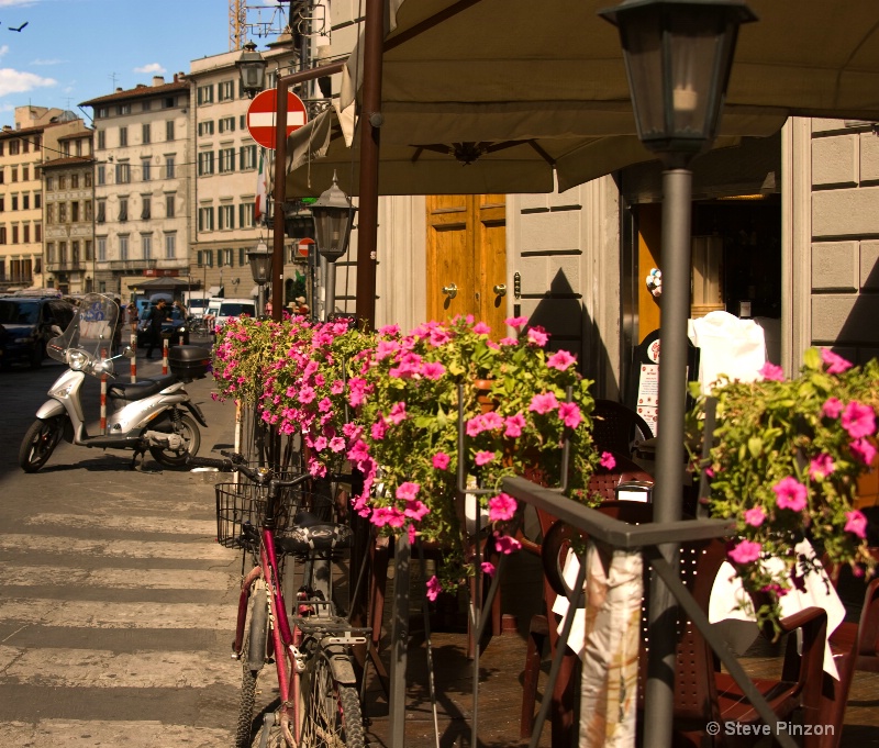 Tables, flowers, bikes, blue skies: 