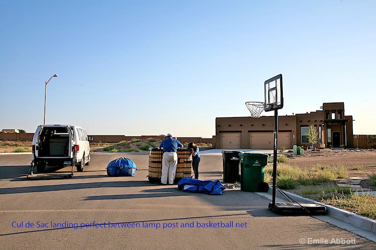 Landing site between the lamp post and basketball 