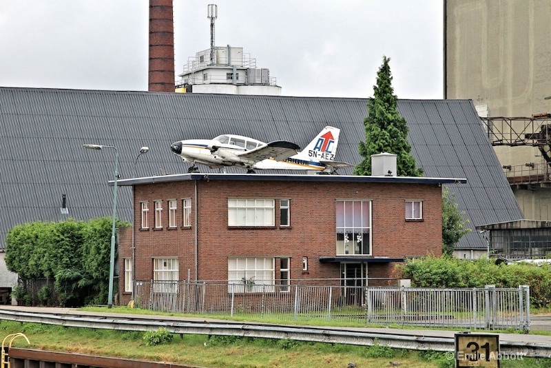 Plane on roof of house