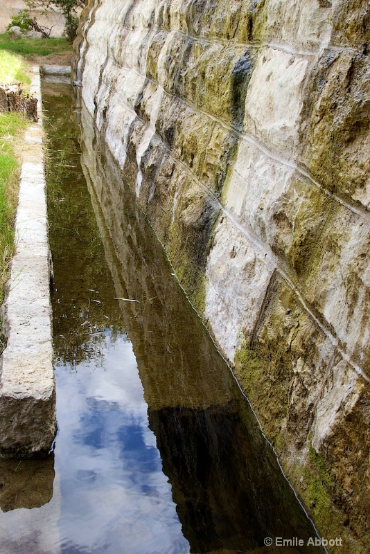 Portion of dam and trough to control release water