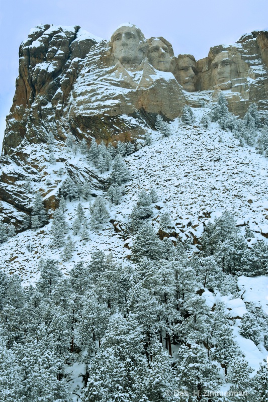 Looking up a snowy Mt. Rushmore