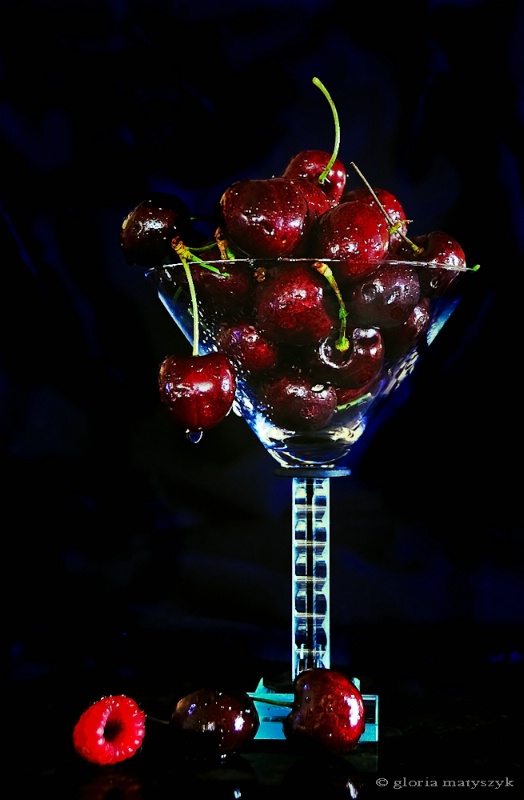 Cherries and a raspberry still life