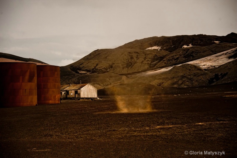Dust Devil and rusted tanks, Antarctica