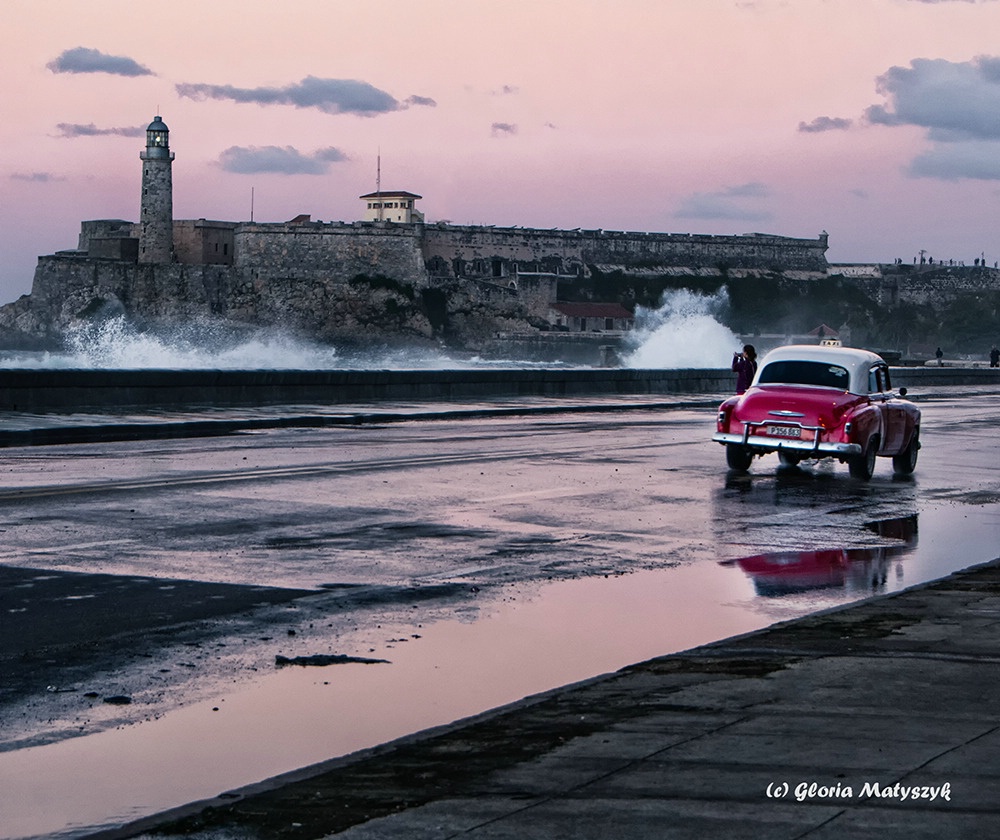 Waves and an old car at sunset in Havana, Cuba