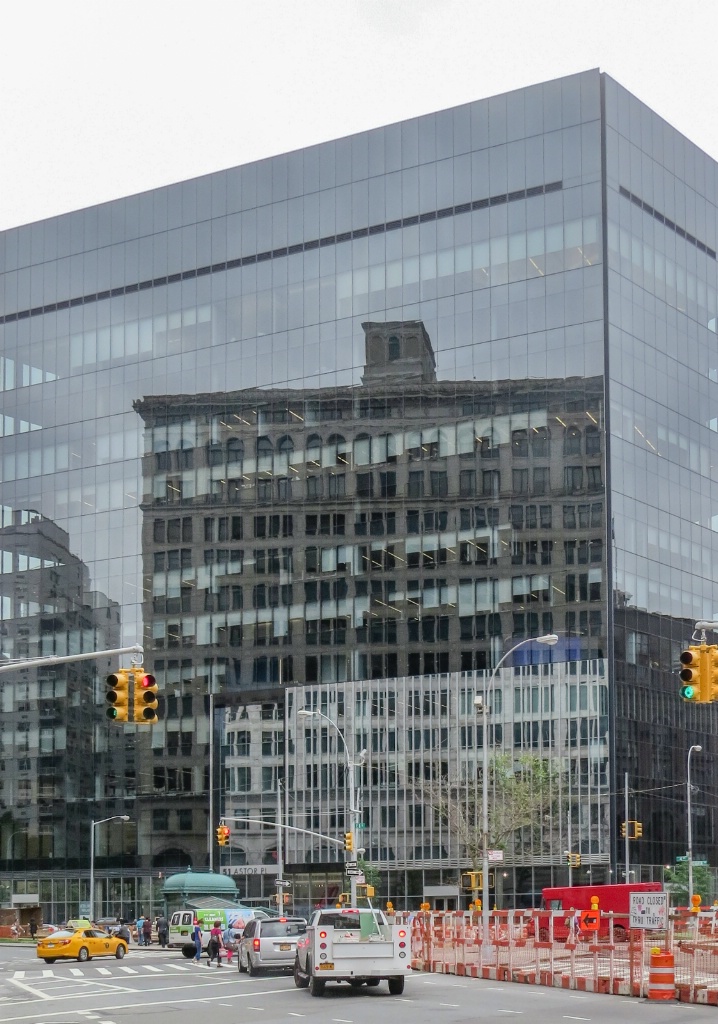 Reflecting at Astor Place in the City