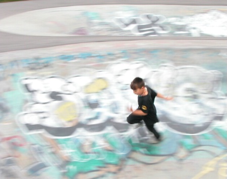 Kid Running in Skateboard Park