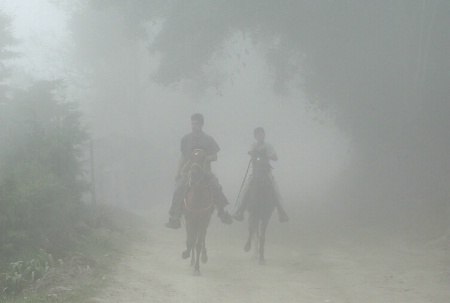 Riders in mist