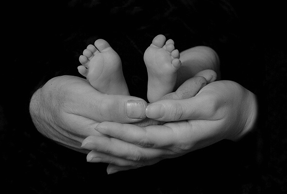 Cradled In His Parents Hands