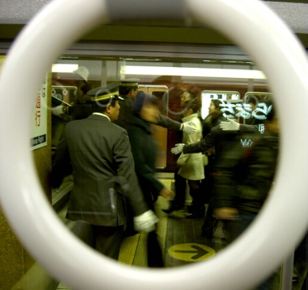 Hands,gloves and crowd in a train station