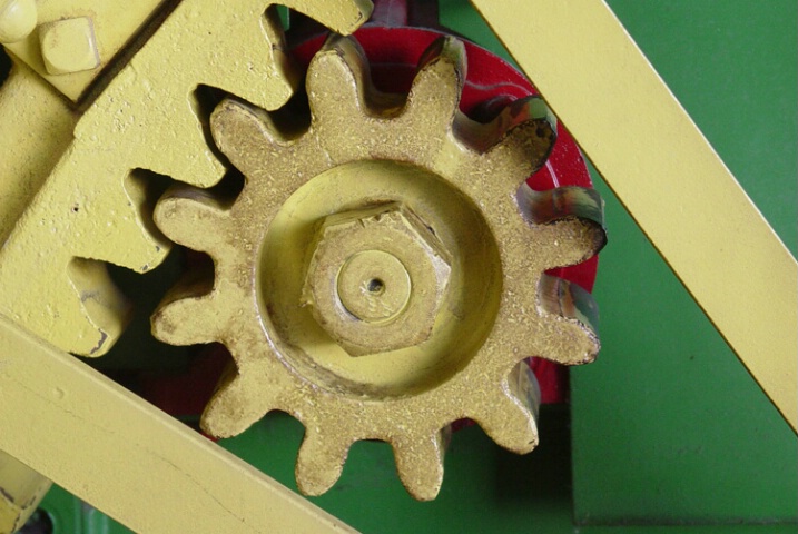  Yellow cog on old farm machine