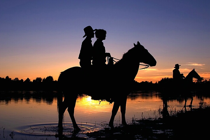 Cowboy Silhouettes at Sunset