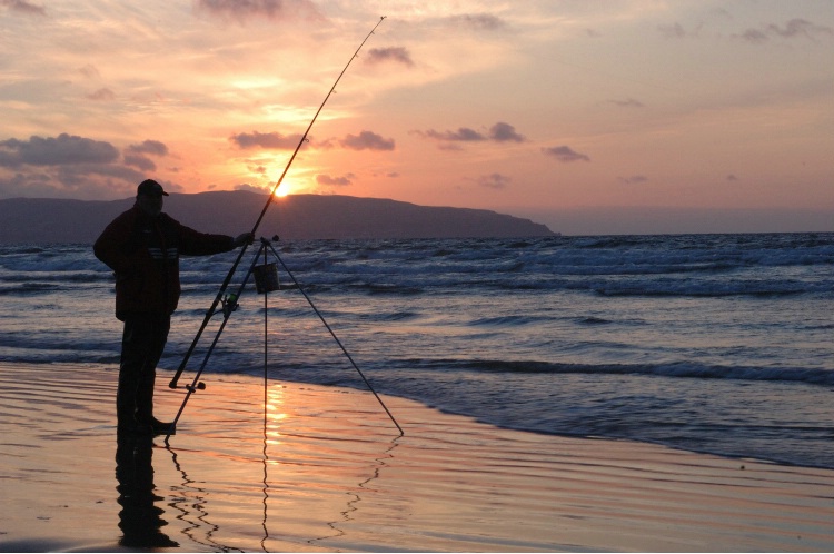 Fishing for Bass late evening off Downhill Beach