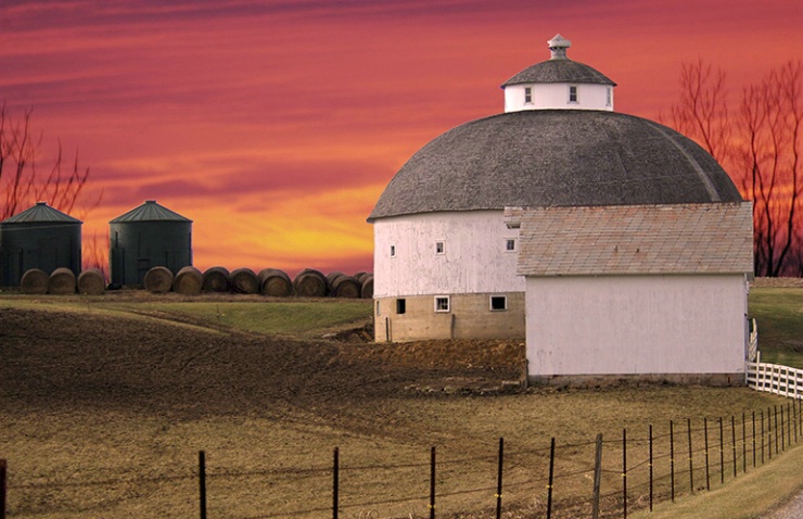 Round Barn and Bales At Sunset