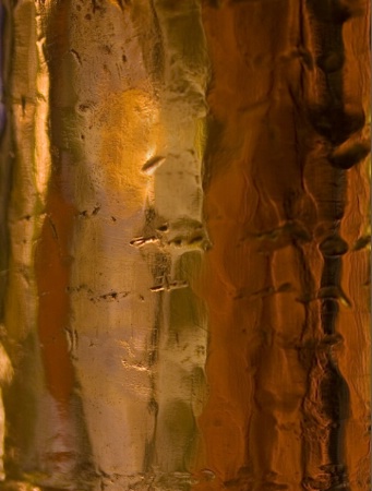 Detail from old, battered, copper pot