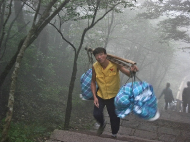 Chinaman carrying heavy load