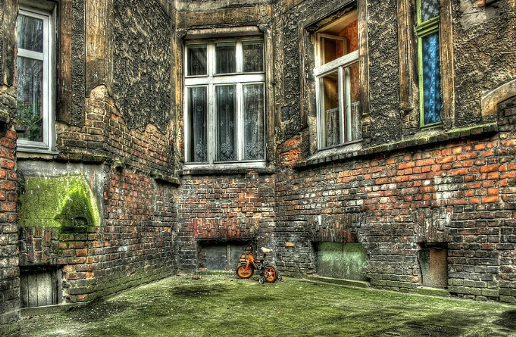 a corner with orange child bicycle