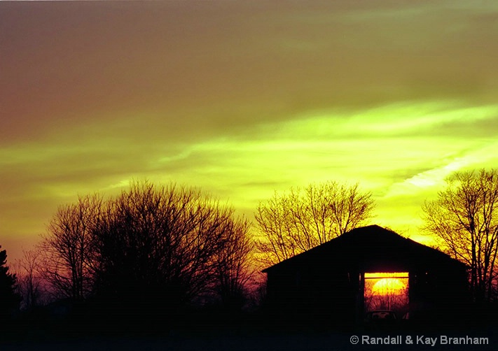 sun_setting_thru_barn_one_day_