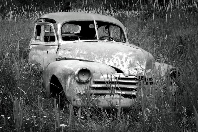 Old abandoned rusted car B&W version 1