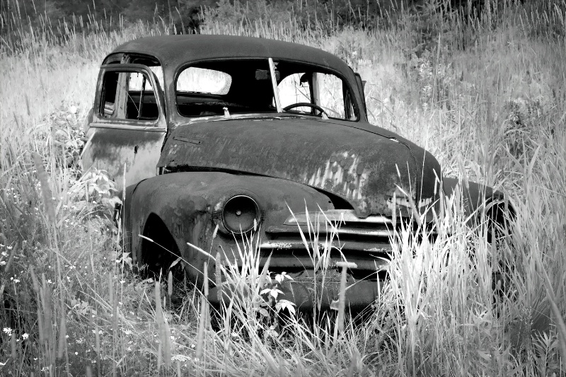 Old abandoned rusted car B&W version 2