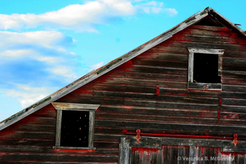 slightly tilted old red barn