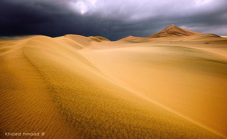 Desert, surrounded by clouds