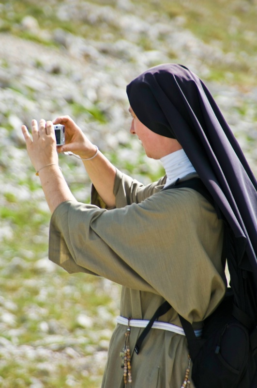 Nun with digital camera, Hills above Piano Grande - ID: 8231389 © Larry J. Citra
