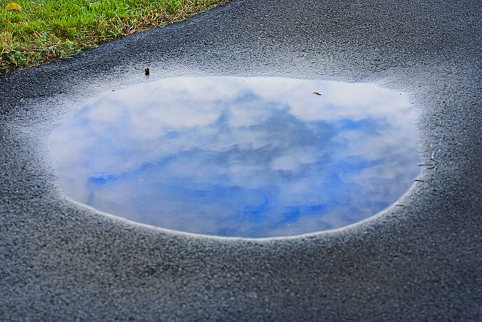 Cloud reflection in puddle
